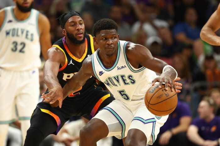 Minnesota Timberwolves guard Anthony Edwards (5) controls the ball against Phoenix Suns forward Josh Okogie (2) in the first half at Footprint Center.